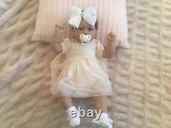 Gorgeous reborn baby girl doll. Hand rooted dark brown hair. 21 ins