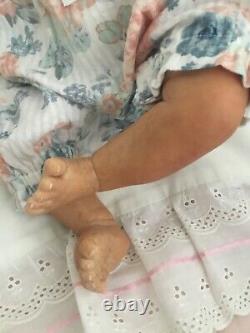 Lovely black, mixed race reborn baby girl doll. Hand rooted hair. 19 ins