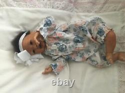 Lovely black, mixed race reborn baby girl doll. Hand rooted hair. 19 ins