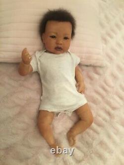 Lovely black, mixed race reborn baby girl doll. Hand rooted hair. 19 ins