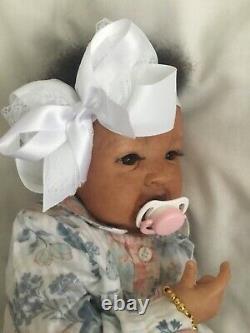 Lovely black, mixed race reborn baby girl doll. Hand rooted hair. 19 ins