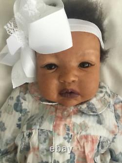Lovely black, mixed race reborn baby girl doll. Hand rooted hair. 19 ins