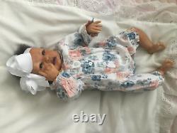 Lovely black, mixed race reborn baby girl doll. Hand rooted hair. 19 ins