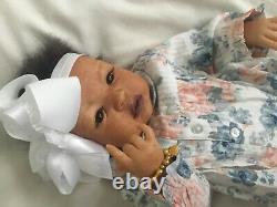 Lovely black, mixed race reborn baby girl doll. Hand rooted hair. 19 ins