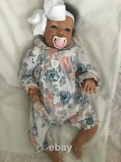 Lovely black, mixed race reborn baby girl doll. Hand rooted hair. 19 ins