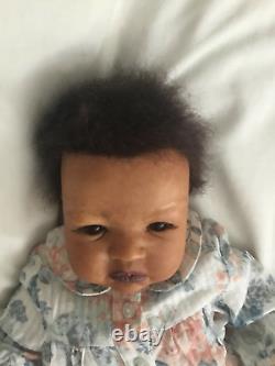 Lovely black, mixed race reborn baby girl doll. Hand rooted hair. 19 ins