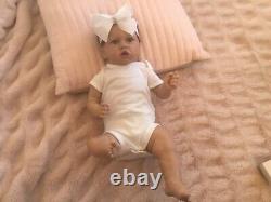 Lovely reborn baby girl doll. Hand rooted dark brown hair. 21 ins