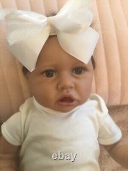 Lovely reborn baby girl doll. Hand rooted dark brown hair. 21 ins