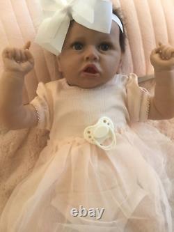 Lovely reborn baby girl doll. Hand rooted dark brown hair. 21 ins