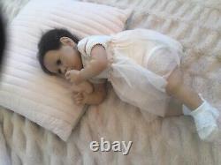 Lovely reborn baby girl doll. Hand rooted dark brown hair. 21 ins