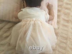 Lovely reborn baby girl doll. Hand rooted dark brown hair. 21 ins