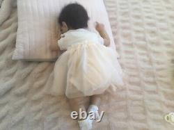 Lovely reborn baby girl doll. Hand rooted dark brown hair. 21 ins