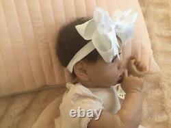 Lovely reborn baby girl doll. Hand rooted dark brown hair. 21 ins