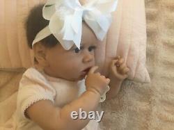 Lovely reborn baby girl doll. Hand rooted dark brown hair. 21 ins