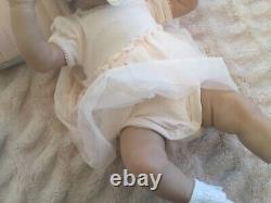 Lovely reborn baby girl doll. Hand rooted dark brown hair. 21 ins