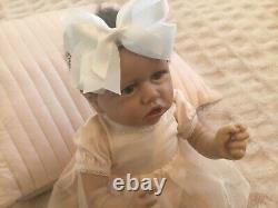 Lovely reborn baby girl doll. Hand rooted dark brown hair. 21 ins