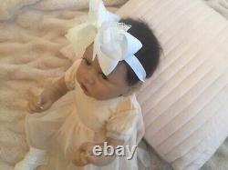 Lovely reborn baby girl doll. Hand rooted dark brown hair. 21 ins