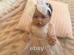 Lovely reborn baby girl doll. Hand rooted dark brown hair. 21 ins