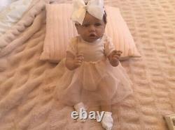 Lovely reborn baby girl doll. Hand rooted dark brown hair. 21 ins