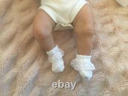 Lovely reborn baby girl doll. Hand rooted dark brown hair. 21 ins