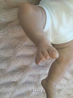 Lovely reborn baby girl doll. Hand rooted dark brown hair. 21 ins