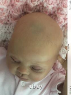 Lovely sleeping, reborn baby girl doll. Anatomically accurate fontanelle. 16 ins