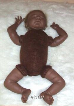 Lucy 15 ethnic reborn doll has rooted hair