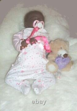 Lucy 15 ethnic reborn doll has rooted hair