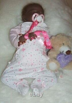 Lucy 15 ethnic reborn doll has rooted hair