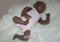 Lucy 15 ethnic reborn doll has rooted hair