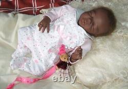 Lucy 15 ethnic reborn doll has rooted hair