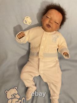 Reborn baby boy biracial doll. Sleeping eyes. Hand rooted Afro hair. 20 ins