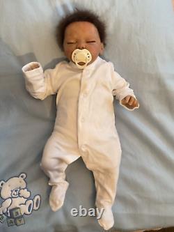 Reborn baby boy biracial doll. Sleeping eyes. Hand rooted Afro hair. 20 ins