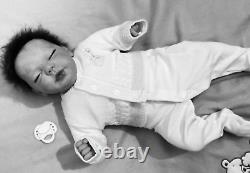 Reborn baby boy biracial doll. Sleeping eyes. Hand rooted Afro hair. 20 ins