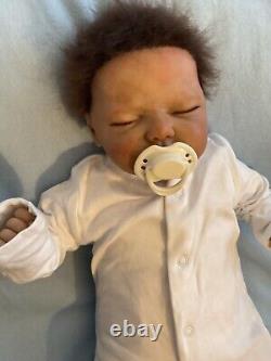 Reborn baby boy biracial doll. Sleeping eyes. Hand rooted Afro hair. 20 ins