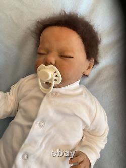 Reborn baby boy biracial doll. Sleeping eyes. Hand rooted Afro hair. 20 ins