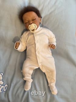 Reborn baby boy biracial doll. Sleeping eyes. Hand rooted Afro hair. 20 ins