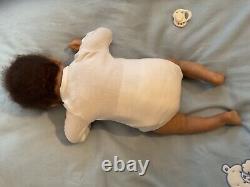 Reborn baby boy biracial doll. Sleeping eyes. Hand rooted Afro hair. 20 ins