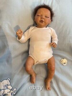 Reborn baby boy biracial doll. Sleeping eyes. Hand rooted Afro hair. 20 ins