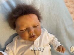 Reborn baby boy biracial doll. Sleeping eyes. Hand rooted Afro hair. 20 ins