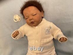 Reborn baby boy biracial doll. Sleeping eyes. Hand rooted Afro hair. 20 ins