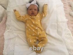 Stunning black, mixed race reborn baby girl doll. Hand rooted hair. 19 ins