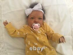 Stunning black, mixed race reborn baby girl doll. Hand rooted hair. 19 ins