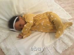 Stunning black, mixed race reborn baby girl doll. Hand rooted hair. 19 ins