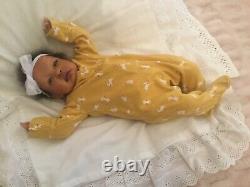 Stunning black, mixed race reborn baby girl doll. Hand rooted hair. 19 ins