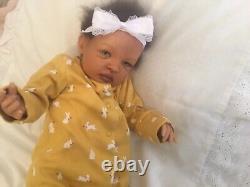 Stunning black, mixed race reborn baby girl doll. Hand rooted hair. 19 ins