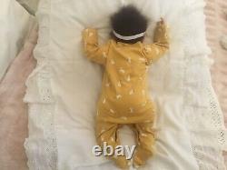 Stunning black, mixed race reborn baby girl doll. Hand rooted hair. 19 ins