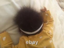 Stunning black, mixed race reborn baby girl doll. Hand rooted hair. 19 ins