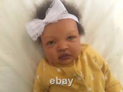 Stunning black, mixed race reborn baby girl doll. Hand rooted hair. 19 ins