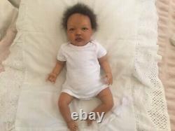 Stunning black, mixed race reborn baby girl doll. Hand rooted hair. 19 ins